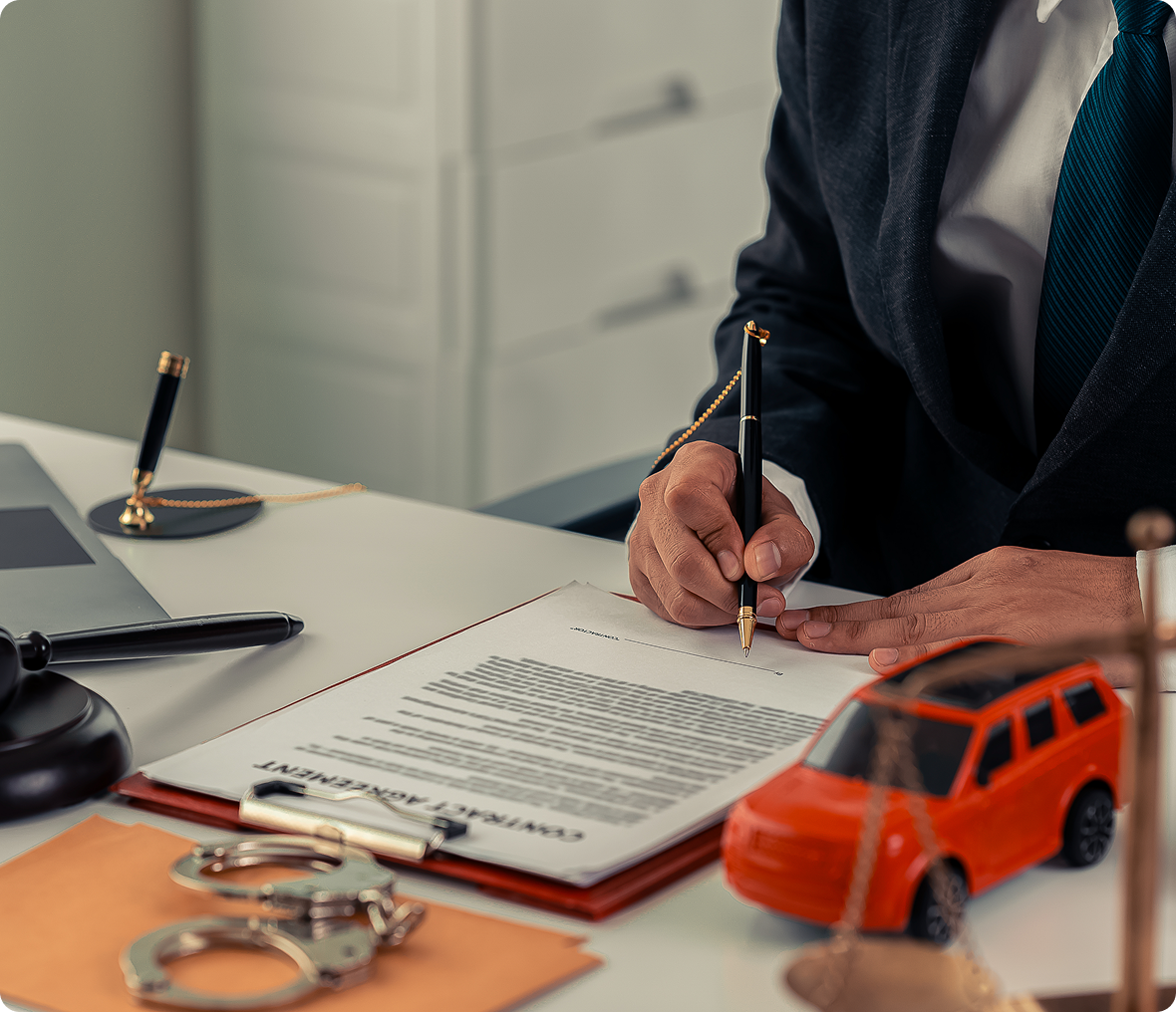 Office desk with contract and toy car