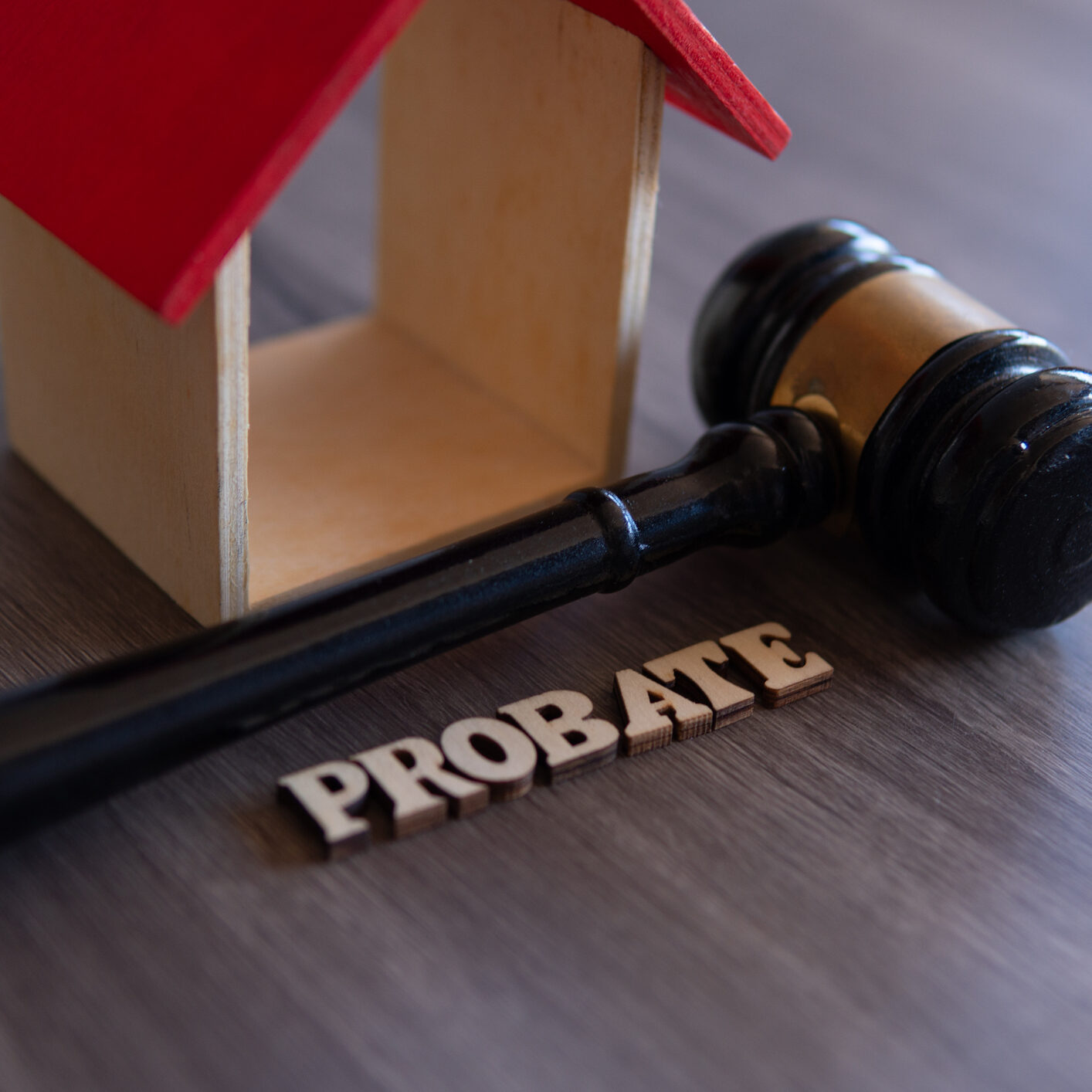 Closeup image of judge gavel, wooden house and word PROBATE. Copy space for text.