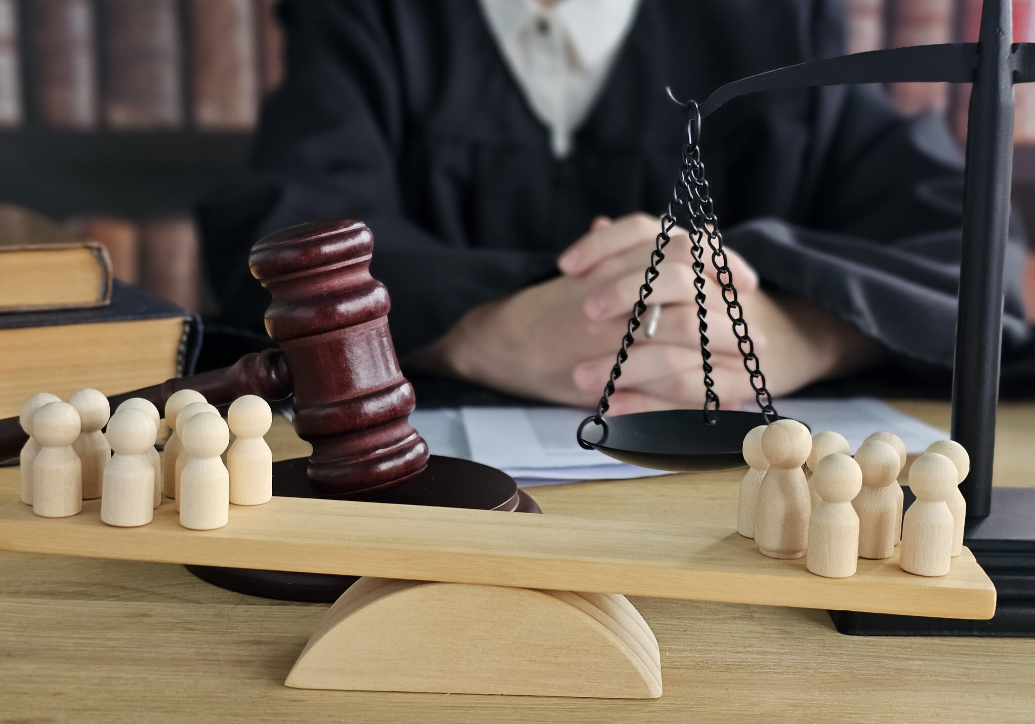 Courtroom scene with wooden figures and gavel representing justice and legal proceedings